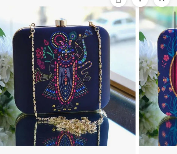 Janmashtami inspired clutch bag with colorful deity design and gold chain strap